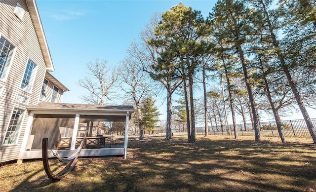 view of yard featuring a sunroom and fence