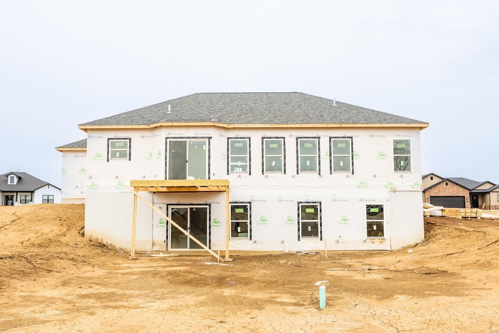 212 Ashurst Ln, Ofallon, IL 62269 - back of property featuring a shingled roof and stucco siding