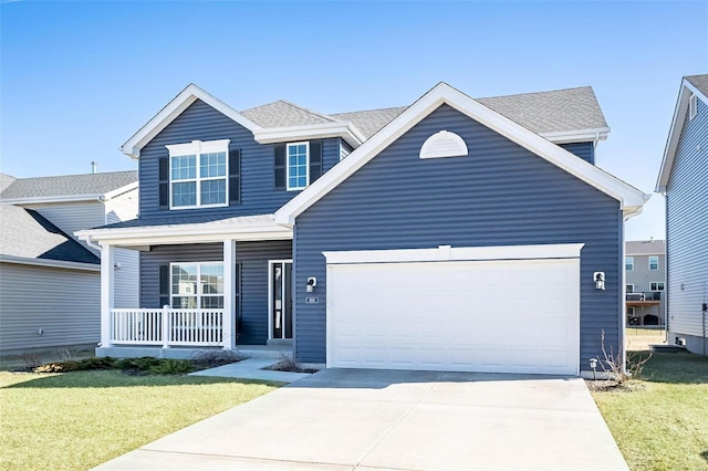 traditional home with a porch, an attached garage, concrete driveway, and a front lawn