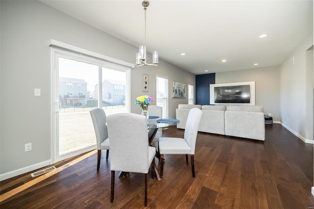 dining space featuring dark wood-style flooring, baseboards, a chandelier, and recessed lighting
