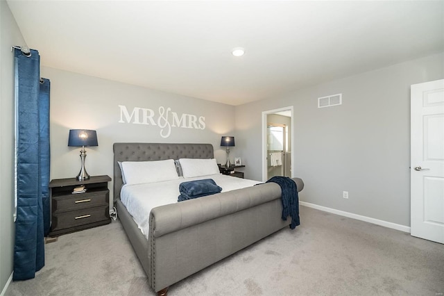 bedroom featuring light carpet, baseboards, and connected bathroom