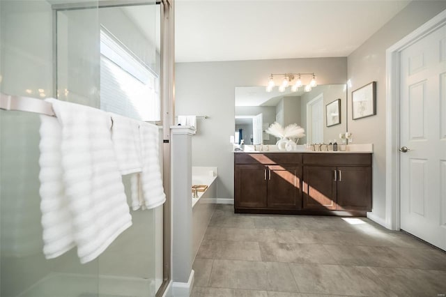 bathroom with a bath, double vanity, baseboards, and a shower with door