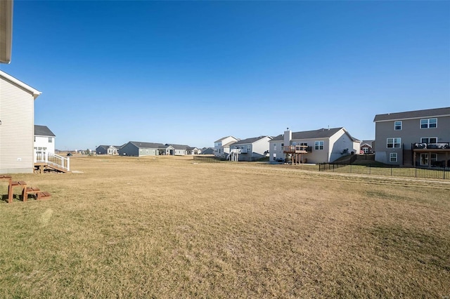view of green lawn with a residential view