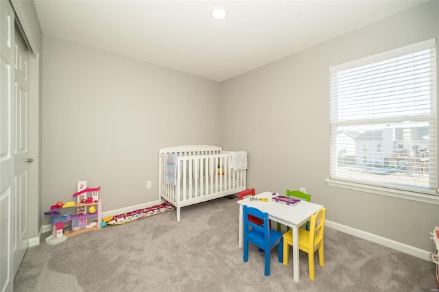 carpeted bedroom featuring multiple windows, baseboards, and a closet