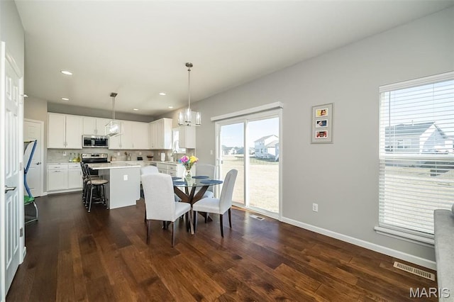 408 Sawgrass Ct, Saint Charles, MO 63301 - dining space with a chandelier, dark wood-style floors, baseboards, and recessed lighting
