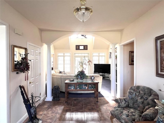 19383 Dabbs N Rd, Jerseyville, IL 62052 - living room featuring ornate columns, arched walkways, and baseboards