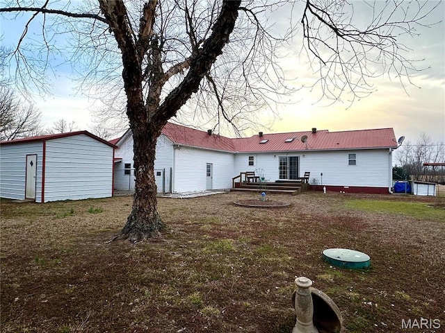 6474 State Highway H, Benton, MO 63736 - rear view of house with metal roof, an outdoor structure, a wooden deck, and a yard