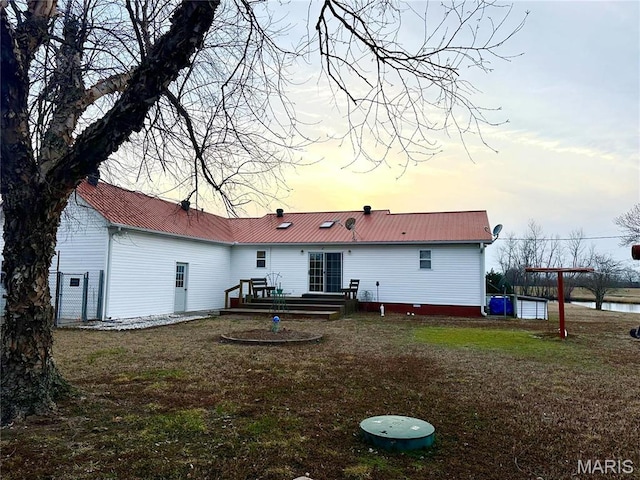 6474 State Highway H, Benton, MO 63736 - back of property at dusk featuring metal roof and a yard