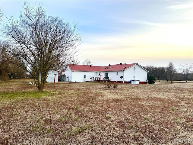 6474 State Highway H, Benton, MO 63736 - back of property at dusk featuring a deck and metal roof