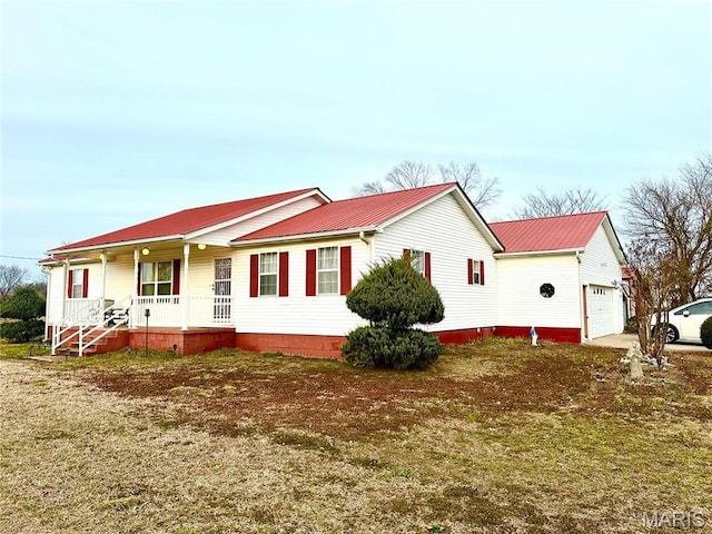 6474 State Highway H, Benton, MO 63736 - view of home's exterior featuring covered porch, an attached garage, metal roof, and concrete driveway