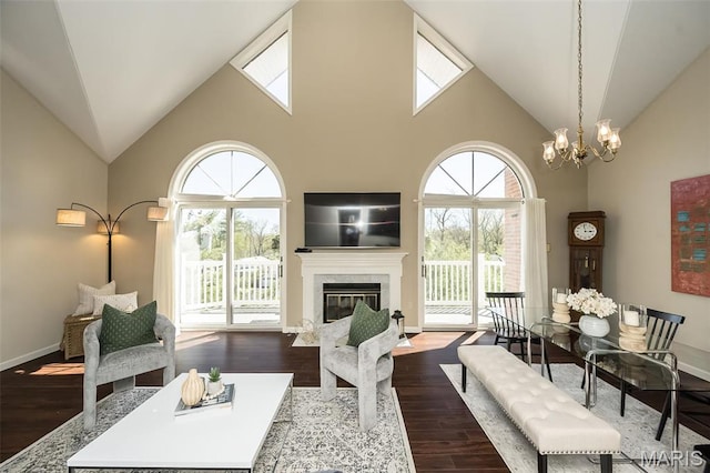 12 Country Club Ter, Glendale, MO 63122 - living room with high vaulted ceiling, healthy amount of natural light, dark wood-style floors, a chandelier, and baseboards