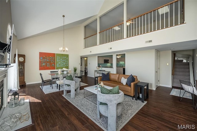 12 Country Club Ter, Glendale, MO 63122 - living room featuring high vaulted ceiling, stairs, a chandelier, baseboards, and wood finished floors