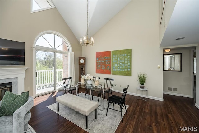 12 Country Club Ter, Glendale, MO 63122 - dining room featuring high vaulted ceiling, baseboards, wood finished floors, a chandelier, and a fireplace