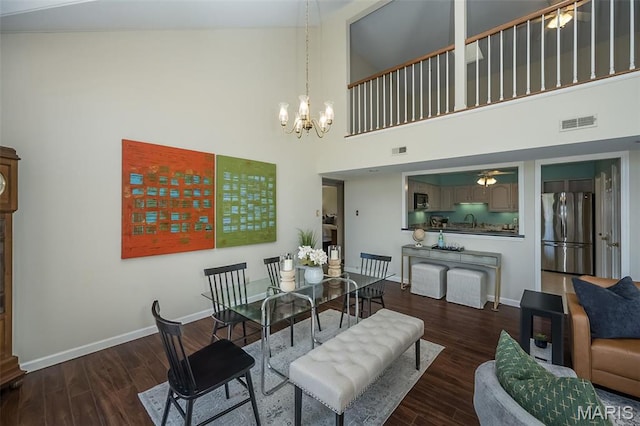 12 Country Club Ter, Glendale, MO 63122 - dining space with a towering ceiling, a chandelier, wood finished floors, baseboards, and a ceiling fan