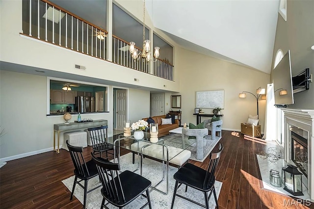 12 Country Club Ter, Glendale, MO 63122 - dining area featuring a high ceiling, dark wood-style flooring, a high end fireplace, baseboards, and a ceiling fan
