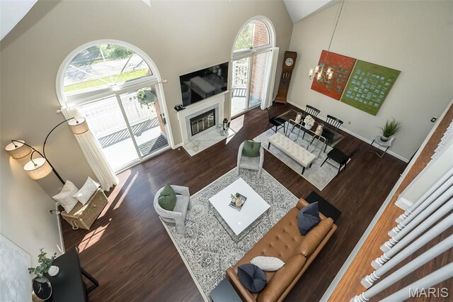 12 Country Club Ter, Glendale, MO 63122 - living room with wood finished floors, high vaulted ceiling, a high end fireplace, and baseboards