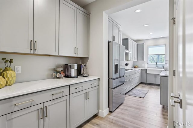5019 Pacific Crest Trl, Cottleville, MO 63304 - kitchen featuring stainless steel fridge with ice dispenser, gray cabinetry, recessed lighting, light wood-type flooring, and gas cooktop