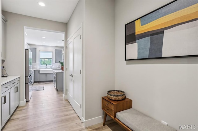 5019 Pacific Crest Trl, Cottleville, MO 63304 - hall with a sink, light wood-type flooring, recessed lighting, and baseboards