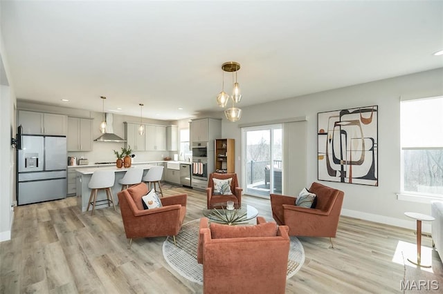 5019 Pacific Crest Trl, Cottleville, MO 63304 - living room featuring plenty of natural light, recessed lighting, baseboards, and light wood finished floors