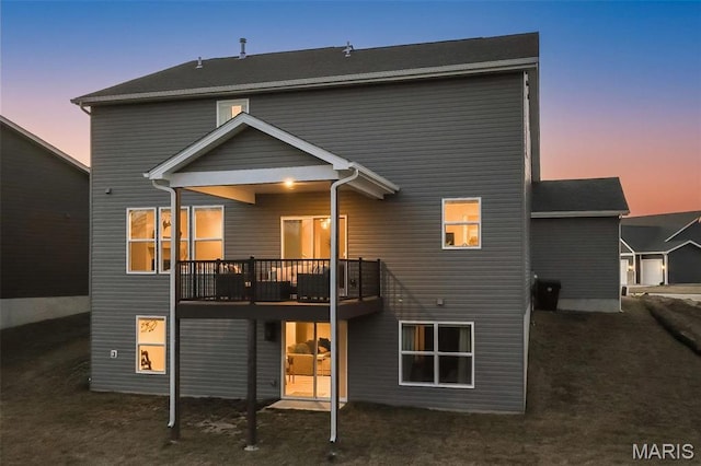 5019 Pacific Crest Trl, Cottleville, MO 63304 - back of property at dusk with a deck