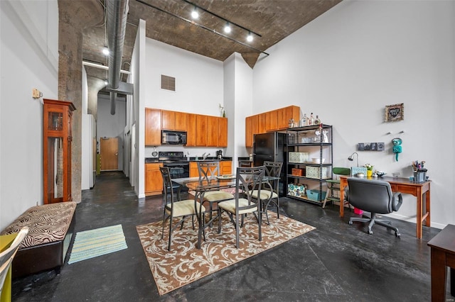 1511 Locust St Unit 101, Saint Louis, MO 63103 - dining space with a high ceiling, rail lighting, finished concrete floors, and an office area