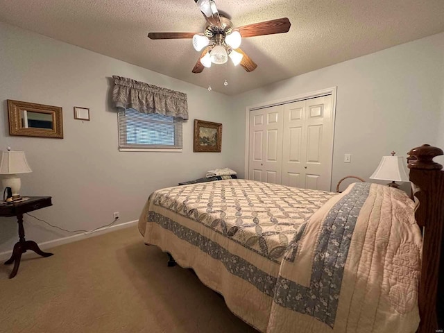 carpeted bedroom featuring a closet, baseboards, a ceiling fan, and a textured ceiling