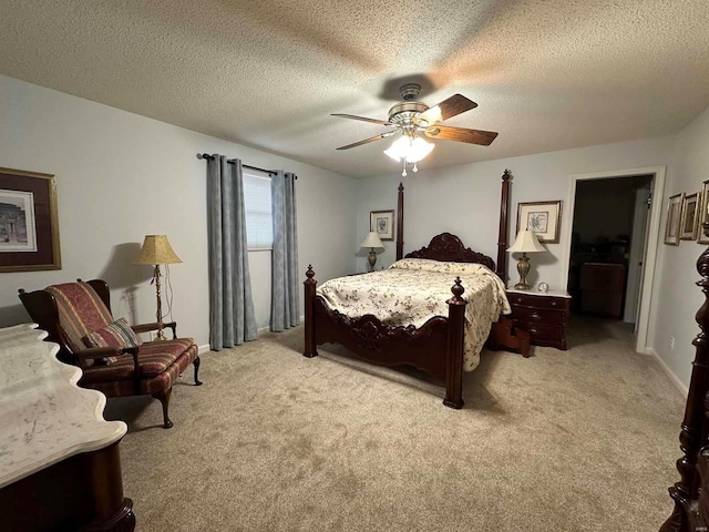 bedroom featuring light colored carpet, a ceiling fan, a textured ceiling, and baseboards