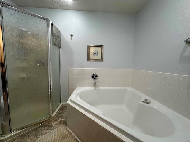full bathroom with a stall shower and a bath