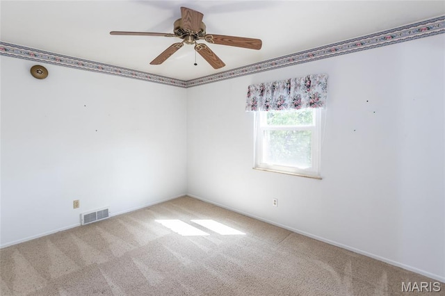 carpeted empty room with baseboards and ceiling fan