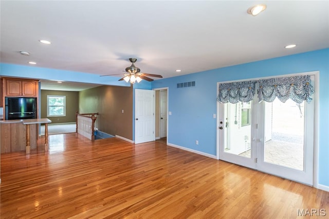 unfurnished living room featuring baseboards, light wood-style floors, recessed lighting, and a ceiling fan