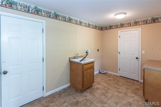 laundry room featuring washer hookup, cabinet space, baseboards, hookup for an electric dryer, and light floors