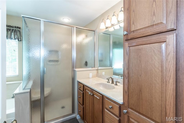 bathroom with a shower stall and vanity
