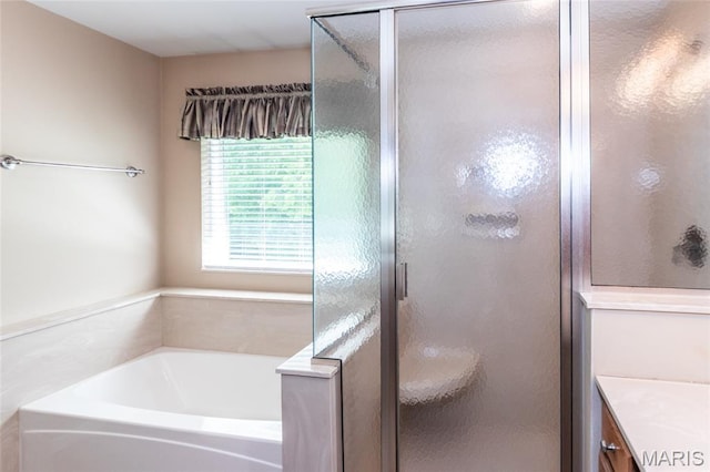 bathroom with a bath, a shower stall, and vanity