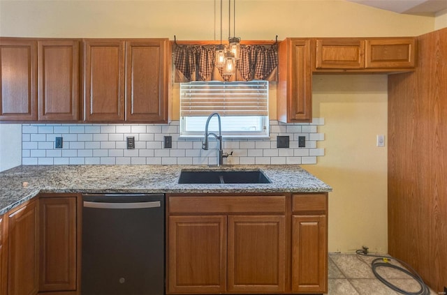 kitchen featuring dishwasher, a sink, decorative backsplash, and brown cabinetry