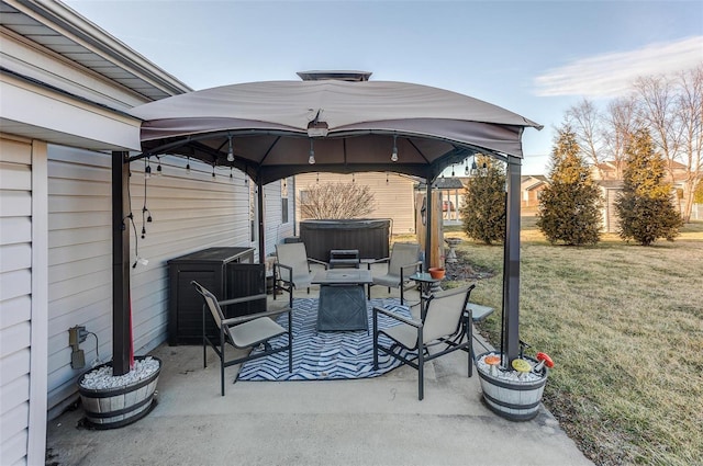 view of patio featuring a hot tub and a gazebo