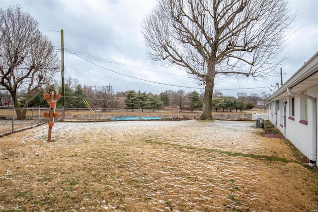 view of yard featuring fence and a pool