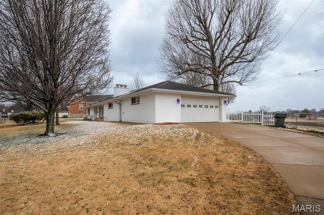 7080 Plainview Ave, Saint Louis, MO 63109 - view of home's exterior with a garage, concrete driveway, and a chimney