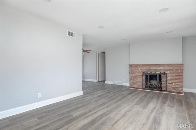 7080 Plainview Ave, Saint Louis, MO 63109 - unfurnished living room featuring wood finished floors, a fireplace, and baseboards
