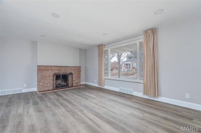 7080 Plainview Ave, Saint Louis, MO 63109 - unfurnished living room with wood finished floors, a fireplace, and baseboards