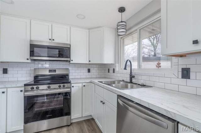 7080 Plainview Ave, Saint Louis, MO 63109 - kitchen featuring appliances with stainless steel finishes, a sink, light countertops, white cabinets, and wood finished floors