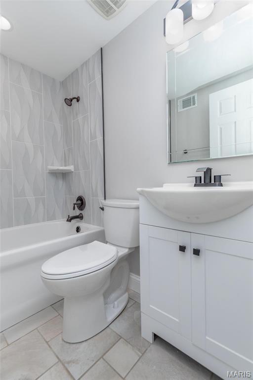 7080 Plainview Ave, Saint Louis, MO 63109 - bathroom featuring toilet, vanity, bathtub / shower combination, baseboards, and marble finish flooring