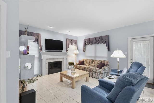 12537 Clark Manor Cir, Creve Coeur, MO 63141 - living room featuring light tile patterned flooring and a fireplace