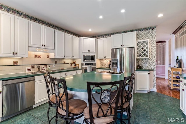 11400 State Road C, Hillsboro, MO 63050 - kitchen with appliances with stainless steel finishes, a breakfast bar area, a sink, white cabinetry, and dark countertops