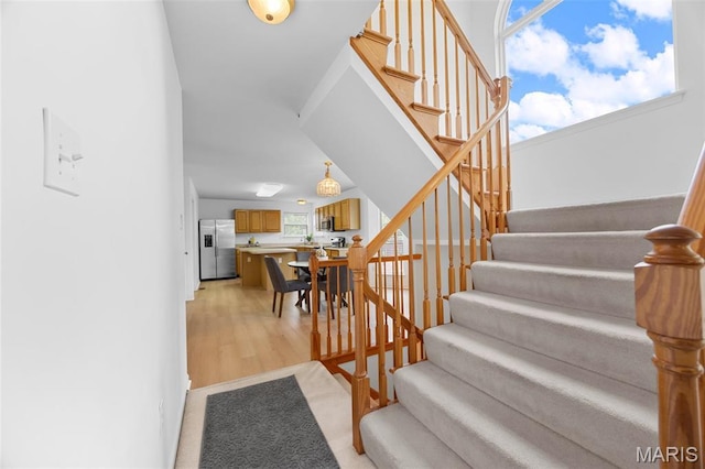 1214 Westrun Dr, Ballwin, MO 63021 - stairs with healthy amount of natural light and wood finished floors