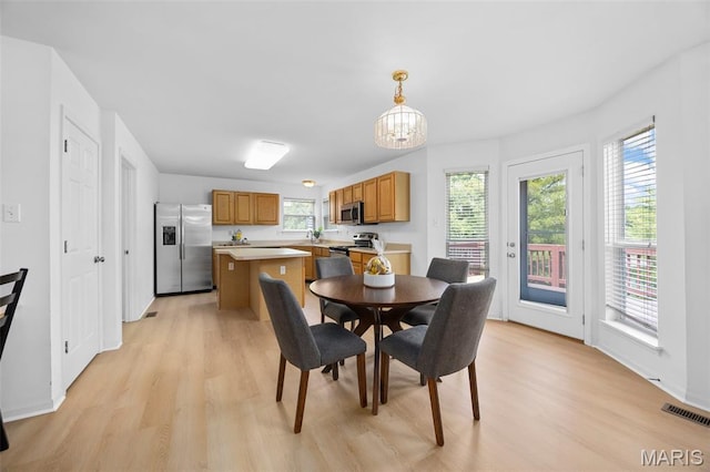 1214 Westrun Dr, Ballwin, MO 63021 - dining room with light wood finished floors and a chandelier