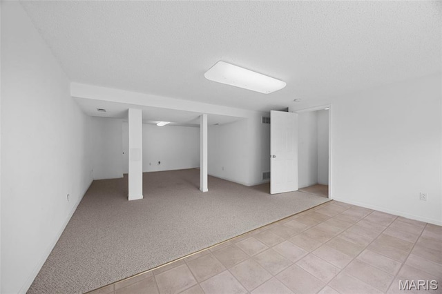 1214 Westrun Dr, Ballwin, MO 63021 - finished below grade area featuring a textured ceiling and light carpet