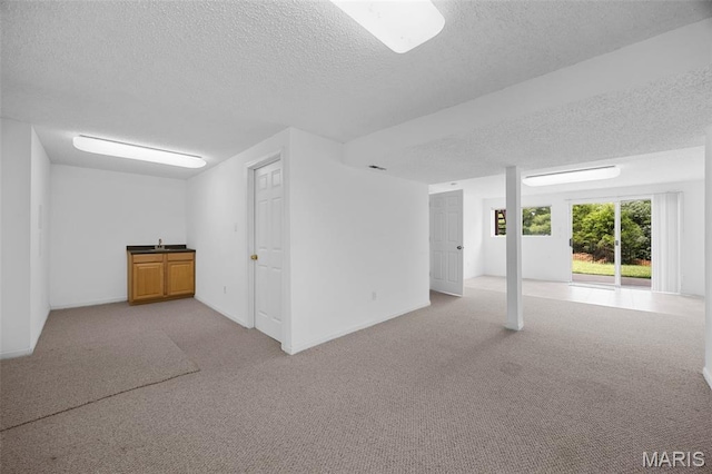 1214 Westrun Dr, Ballwin, MO 63021 - below grade area featuring a textured ceiling and carpet flooring