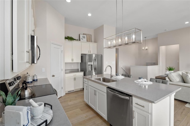 3248 River Breeze Ct, Saint Charles, MO 63301 - kitchen with a sink, stainless steel appliances, open floor plan, light wood-style floors, and recessed lighting
