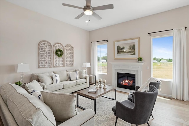 3248 River Breeze Ct, Saint Charles, MO 63301 - living area featuring ceiling fan, light wood-style floors, a fireplace, and baseboards