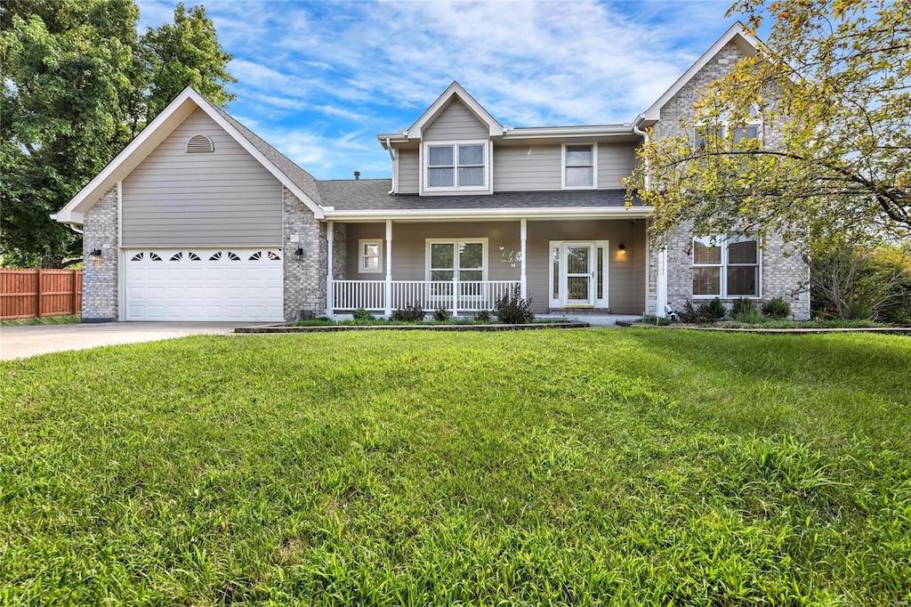 26 Bluff Spring Ct, Saint Charles, MO 63303 - traditional-style home with covered porch, an attached garage, concrete driveway, and brick siding